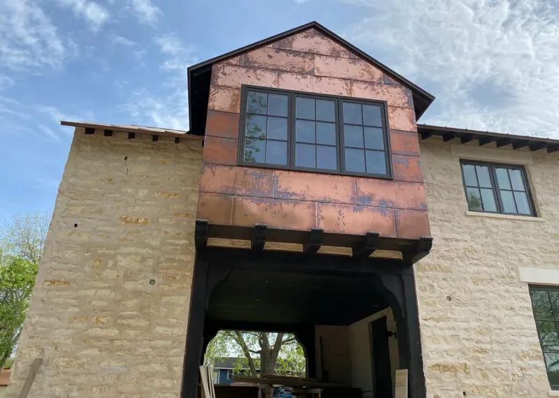 Copper metal panel facade on a stone building for Skylight Installation in Los Osos